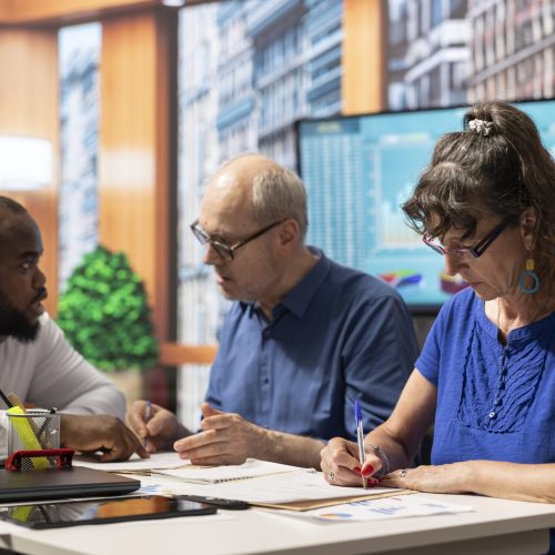 Elderly people signing the retirement plan contract in a meeting with adviser, choosing the perfect investment to secure their pension and future income. Sign the document terms.