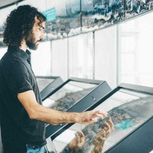 man-using-technology-at-modern-building-2024-10-14-22-32-51-utc